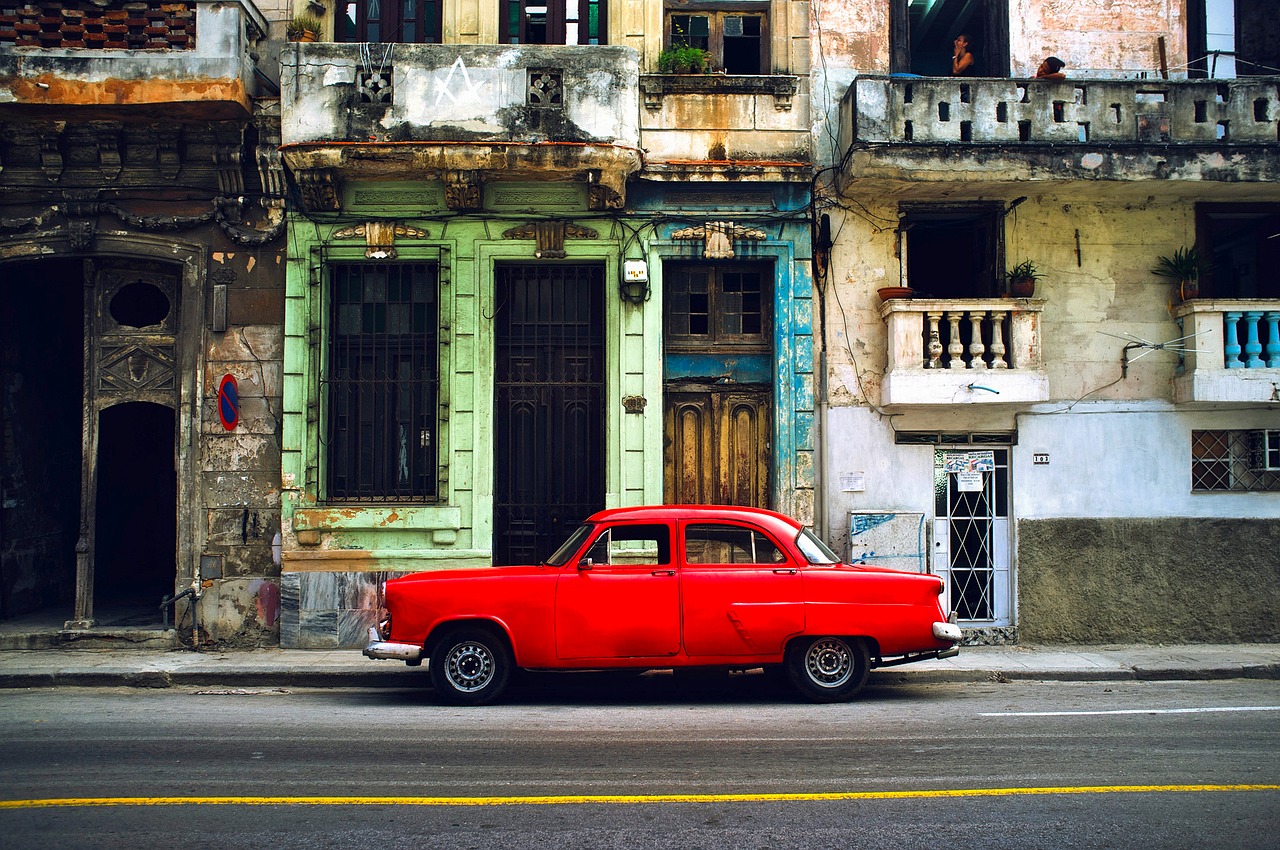 Una via colorata dell'Avana a Cuba con auto d'epoca parcheggiate